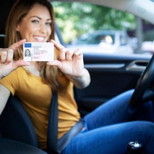 Woman holding up driver's license