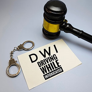 A gavel, handcuffs, and a document about DWI, California DUI Offender Law